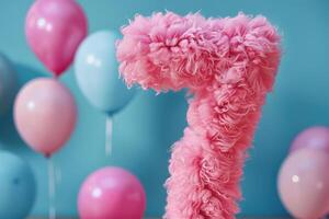 Pink, girlish and fluffy number seven with blurred balloons on the background. Playful symbol 7. Invitation for seventh birthday celebration. Children, kids party. Greeting card design. photo