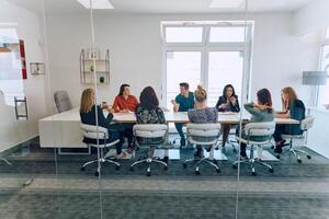 Diverse Business Team Discussing Projects in a Modern Glass Office. photo