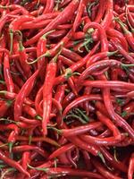 Red hot chilli peppers texture background, close up, A backdrop of Red hot chilli peppers, Street vegetable market, Group of Red hot chilli peppers photo