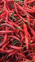 Red hot chilli peppers texture background, close up, A backdrop of Red hot chilli peppers, Street vegetable market, Group of Red hot chilli peppers photo