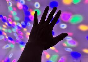Hand gesture silhouette on a colorful background reaching out, saying hello, and show number represent photo