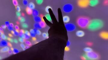 Hand gesture silhouette on a colorful background reaching out, saying hello, and show number represent photo
