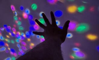Hand gesture silhouette on a colorful background reaching out, saying hello, and show number represent photo