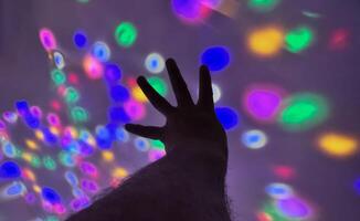 Hand gesture silhouette on a colorful background reaching out, saying hello, and show number represent photo