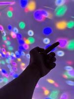 Hand gesture silhouette on a colorful background reaching out, saying hello, and show number represent photo