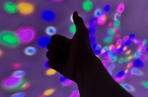 Hand gesture silhouette on a colorful background reaching out, saying hello, and show number represent photo