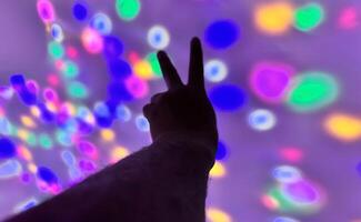 Hand gesture silhouette on a colorful background reaching out, saying hello, and show number represent photo