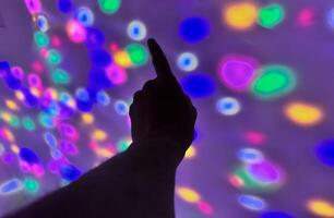Hand gesture silhouette on a colorful background reaching out, saying hello, and show number represent photo