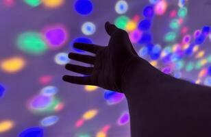 Hand gesture silhouette on a colorful background reaching out, saying hello, and show number represent photo