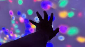 Hand gesture silhouette on a colorful background reaching out, saying hello, and show number represent photo
