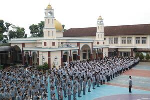 Subang, Indonesia - May 2024, Middle school, high school students and teachers taking part in a ceremony to commemorate National Education Day on the school field photo