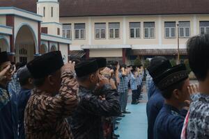 Subang, Indonesia - May 2024, Teachers are in a respectful position towards the flag during activities to commemorate National Education Day in the school field photo