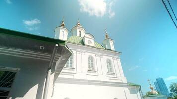 Bottom view of a white church building. Action. Concept of architecture and religion, renovated facade of a building on a cloudy sky background. video