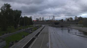 Grey city.Stock footage.Drone view of a big city with various beautiful buildings and a long dirty river and visible gray clouds over the city. video