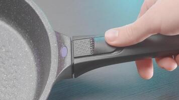 Close up of new frying pan with removable handle. Action. Concept of kitchen utensils for cooking. video