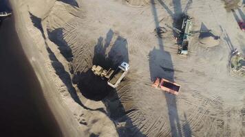 Aerial top view of trucks and machinery in the sand quarry. Scene. Sand pit, loading wagon sand, concept of heavy industry. video