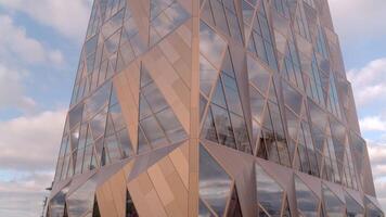Russia, Yekaterinburg - May 13, 2022. Top view of modern architecture of office building. Stock footage. Glass windows with stylish design of architecture of modern building. Headquarters of Russian video