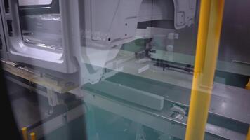 Conveyor tape in the automotive industry. SCENE. A close-up of a conveyor belt at the factory. Gray-yellow conveyor. Automobile factory from the inside video