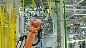 Robotic mechanism, industrial robot iin motion at the modern factory. Scene. Concept of heavy industry and machinery. video