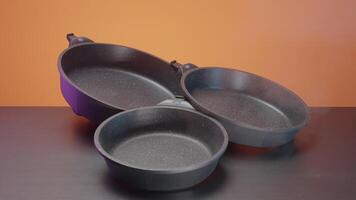 New clean frying pan. Action. Close-up of coating of modern frying pan. New model of frying pan with coating and stylish design video