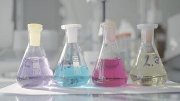 Bright multicolored test tubes .Action.Multicolored chemical solutions standing in a row are in the glass and covered with lids. video