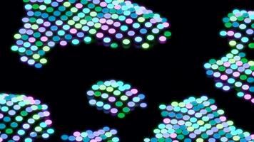 Abstract pixelated pattern with colorful circles waving like clouds on a black background, seamless loop. Design. Blinking and jumping multicolored circles. video