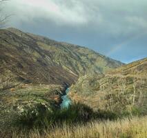 Rainbow between the mountain over the waterfall photo