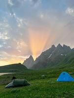 Sunset behinds the mountain and tent photo