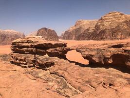 The arch bridge in the middle of desert photo