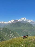 Tables set on the hill and mountain peak. photo