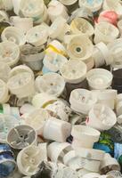 A pattern of many used and soiled nozzles from spray cans with aerosol paint. Background texture of the street art of drawing graffiti on the walls photo