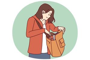 Woman looks into large bag hanging on shoulder in search of wallet or phone lost in handbag vector