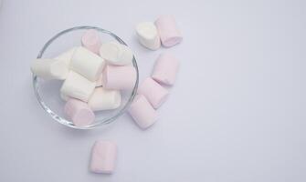 Fluffy white marshmallow macro isolated over white background. photo