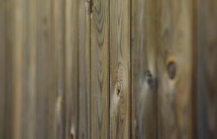 Old grunge dark brown wood panel pattern with beautiful abstract grain surface texture, vertical striped background or backdrop in architectural material decoration concepts, vintage or retro style photo