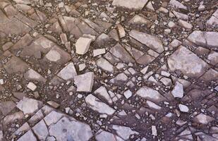 Background of shattered stony stones surface in mountain area. Texture with natural light photo
