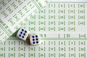 Lottery tickets and dice on blank bills with numbers for playing lottery photo
