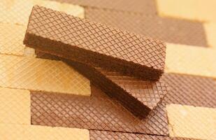 Stacked delicious chocolate wafers in large amount. Two different flavours of classic waffles photo