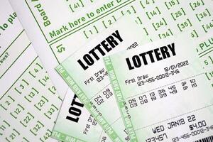 Green lottery tickets and blank bills with numbers for playing lottery photo