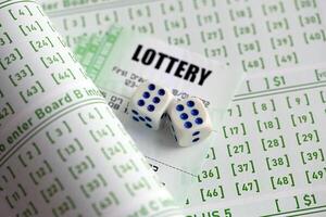 Lottery tickets and dice on blank bills with numbers for playing lottery photo