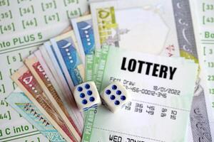 Green lottery tickets and iranian money bills on blank with numbers for playing lottery photo
