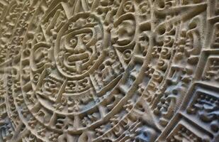 Ancient Mayan Calendar or Aztec calendar with rough relief surface photo