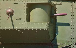 The texture of the wall of the tank, made of metal and reinforced with a multitude of bolts and rivets. Images of the covering of a combat vehicle from the Second World War with a guided machine gun photo