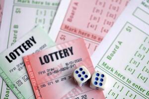 Green and red lottery tickets with dice on blank bills with numbers for playing lottery photo