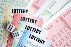 Lottery tickets of different colors and dice on blank bills with numbers for playing lottery photo