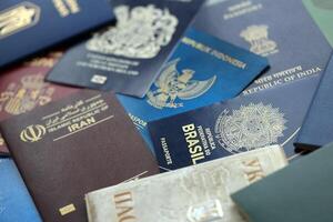 Many various passports of citizens of different countries and regions of the world photo