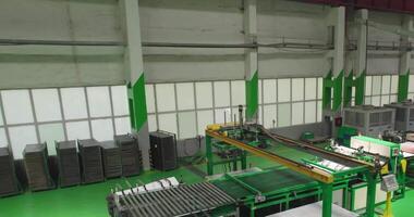 The drone flies in a large workshop on an automatic conveyor. video