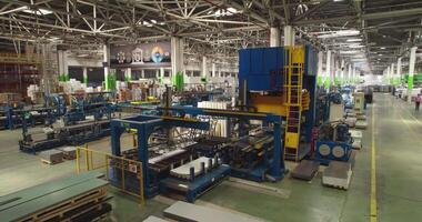 The drone flies in a large workshop on an automatic conveyor. video