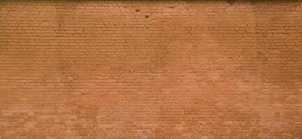 The texture of the brick wall of many rows of bricks painted in brown color photo
