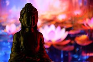 Buddha Purnima and Vesak day concept, Buddha statue with low key light against beautiful and colorful background. Meditation photo