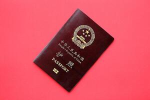 Red passport of People Republic of China. PRC chinese passport on bright background photo